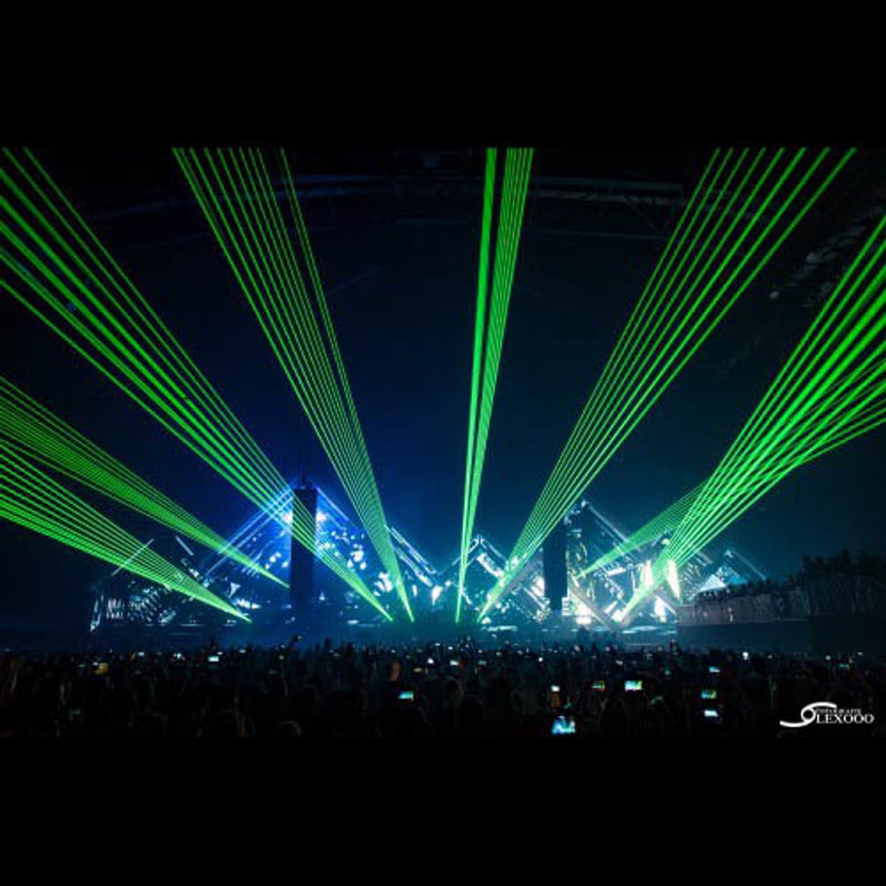 Pair of Kvant ClubMax 3000 lasers in action with RGB beams over a crowd.  Rent a laser now!