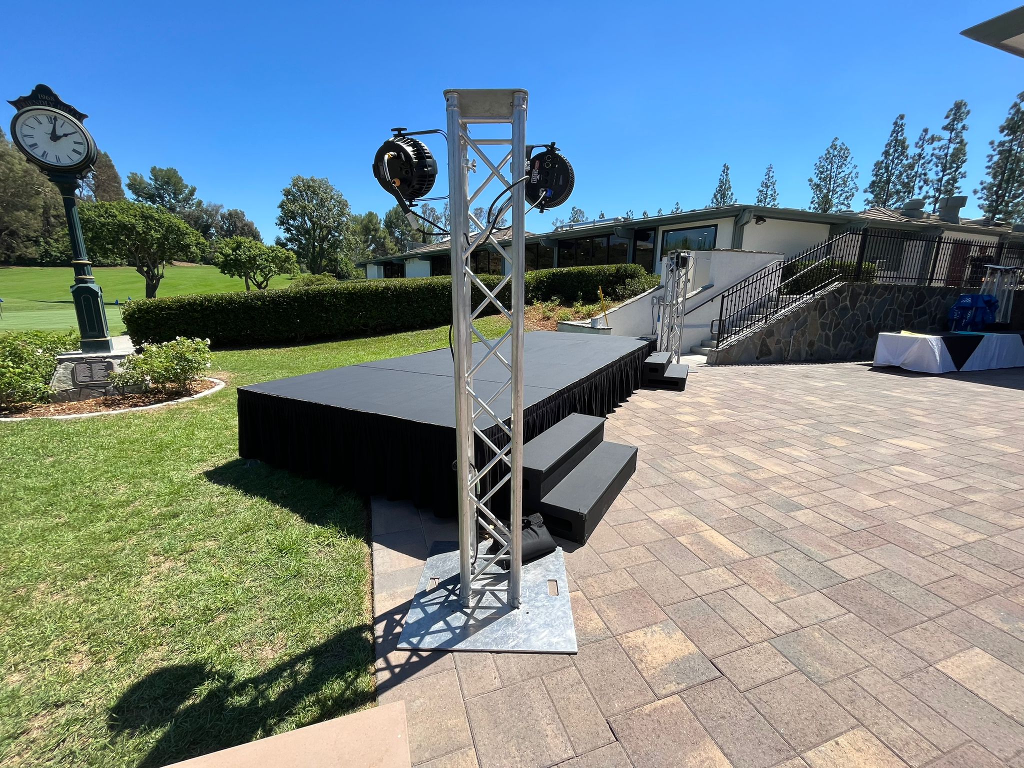 20' W x 8' D x 2' H Steeldeck mobile stage rental with wood stairs and event lighting for concerts, schools, and outdoor events