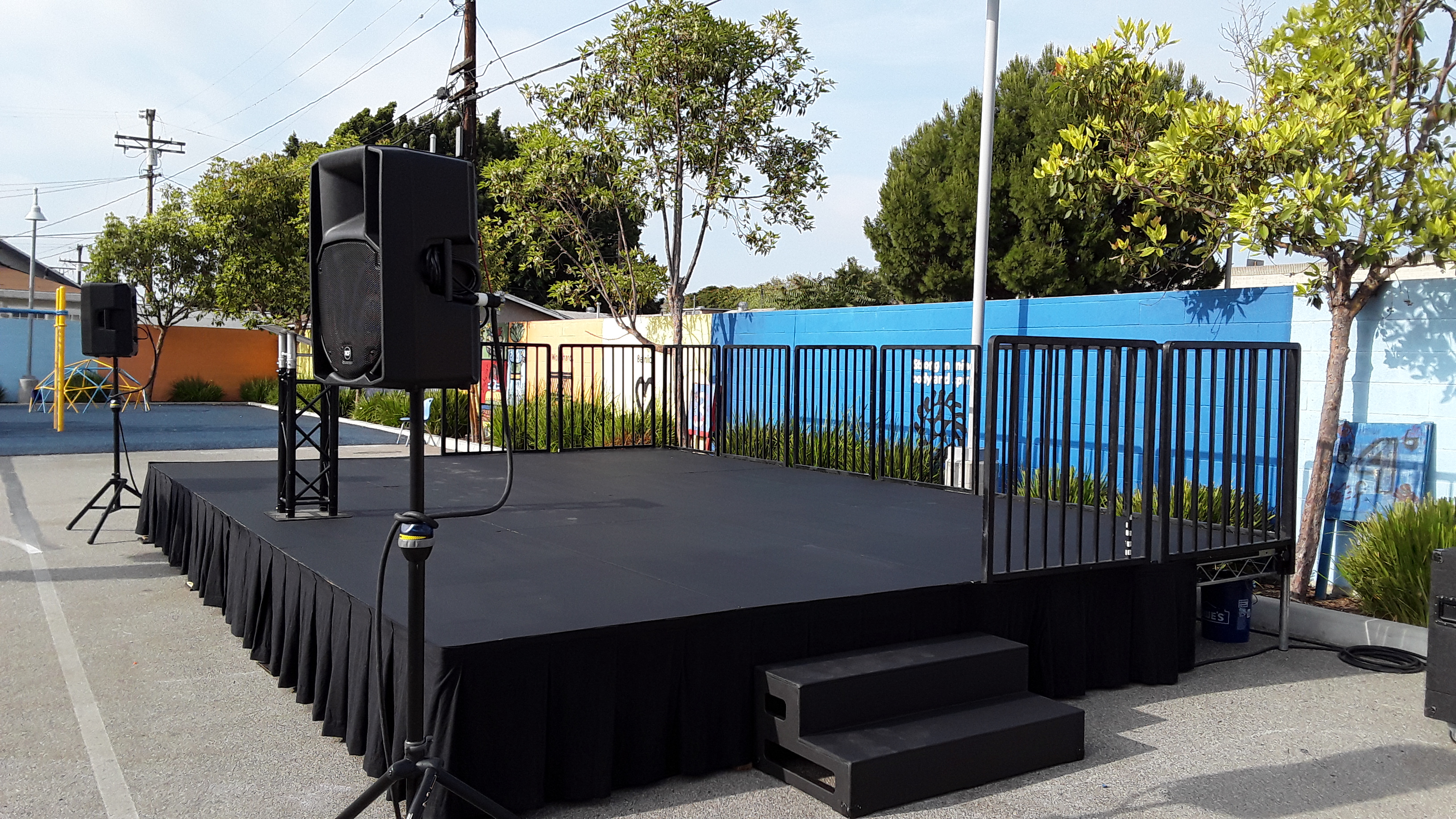 24' W x 12' D x 2' H Steeldeck mobile stage rental with wood stairs and professional sound system for Southern California events